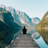 A photo of someone at the edge of a pier, looking between the valley